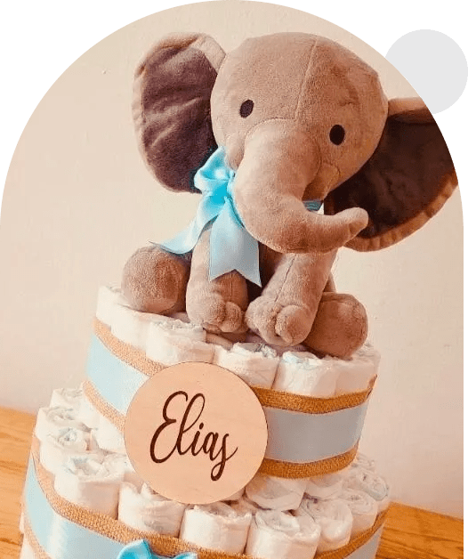 A baby shower cake with an elephant on top.