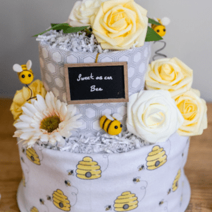 A cake with bees and flowers on it