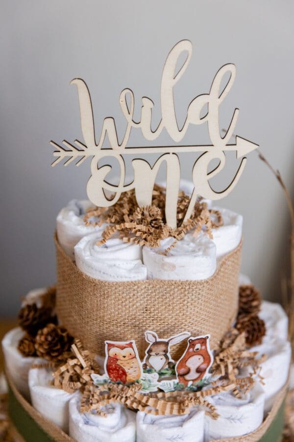 A cake with a wooden topper and some pictures on top of it