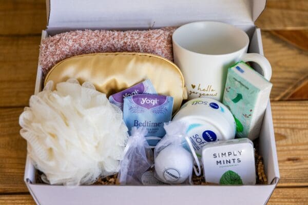A box of various items including a donut, cup and soap.